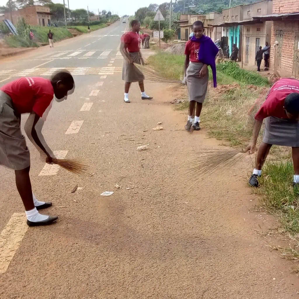 Students cleaning a trading Centre